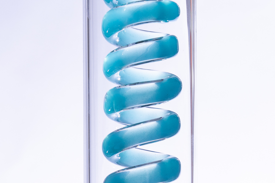 Close-up of a blue gel spiral in a clear tube.