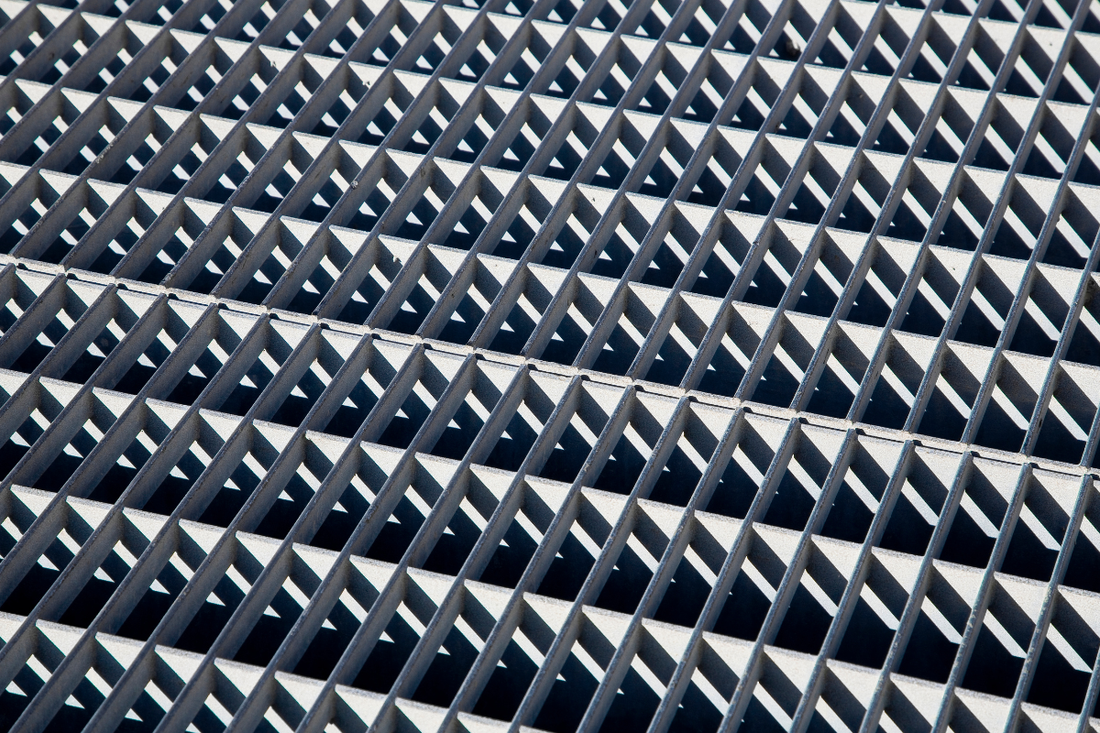 Geometric concrete grid with repeating triangular pyramid pattern