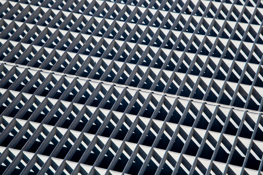 Geometric concrete grid with repeating triangular pyramid pattern