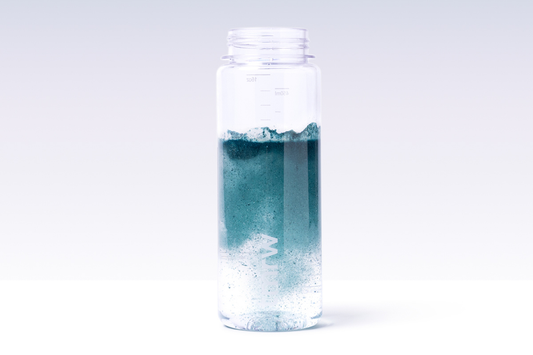 Blue Tmrw powder dissolving in water bottle.